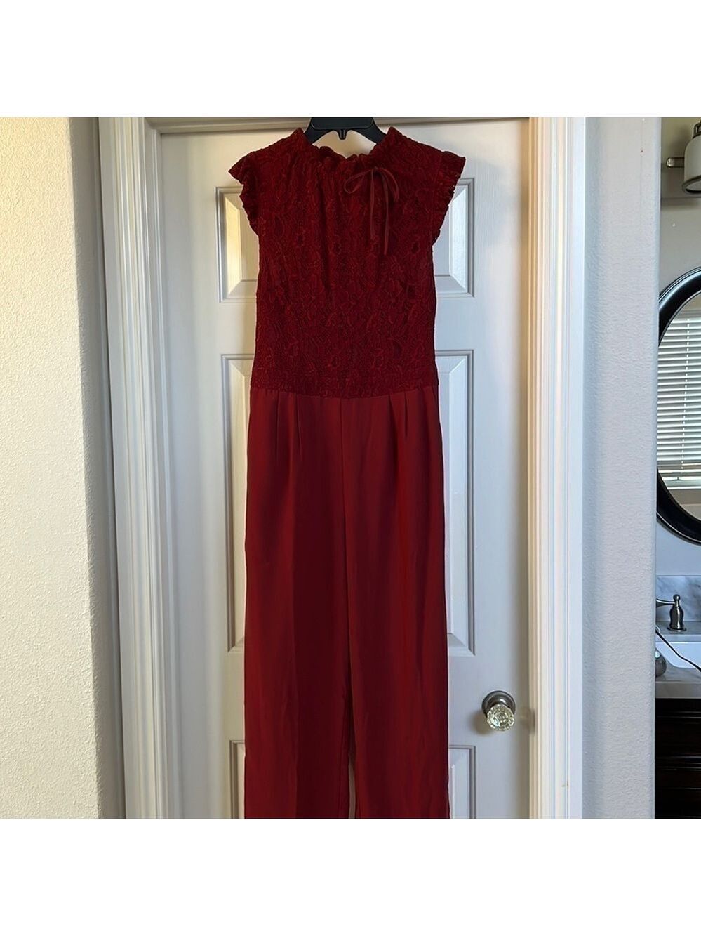 Womenโs maroon jumpsuit. Lace top and silky bottom. Never worn. Size M